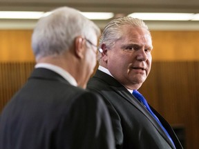 Ontario PC Leader Doug Ford (right) stands with former interim leader Vic Fedelli while taking questions from journalists during a pre-budget lock-up, as the Ontario Provincial Government prepares to deliver its 2018 Budget at the Queens Park Legislature in Toronto, on Wednesday, March 28, 2018. THE CANADIAN PRESS