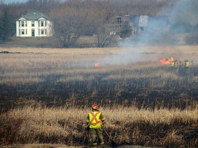Intelligencer file photo
Prince Edward County firefighters battle a grassfire in Sophiasburgh in the spring of 2015. Regional fire chiefs are encouraging people to pay close attention to burning regulations in their municipality.