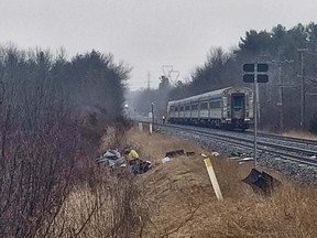 Cris Vilela/For The Whig-Standard
A heavily damaged vehicle rests off the railway tracks after it was struck by a Via Rail train near County Road 7 north of Bath, Thursday, March 29. The vehicle, which police had been pursuing, was vacant when it collided with the train. Police say three suspects were in the vehicle and apprehended at the scene. Two other suspects were nabbed by police earlier in the pursuit.