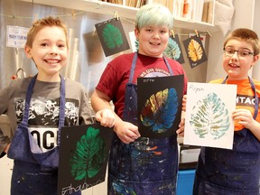 Ethan Currie, 10, left, Jeff Waller, 11, and Ryan Kitchen, 9, hold up artwork they created at the Art Pod program at the Judith and Norman Alix Art Gallery in Sarnia. The pilot program includes art classes for youth with special needs. Tyler Kula/Sarnia Observer/Postmedia Network