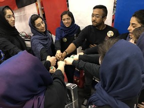 Thuvishan Rajagulasingam, the Canadian mentor for the Afghan Dreamers, gives a pep talk to the six girls from Afghanistan who competed in the Ontario District North Bay Robotic Competition held this past weekend at the Robert J. Surtees Athletic Centre at Nipissing University.