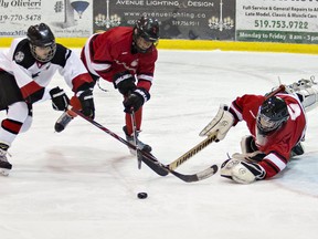 Anthony Pietramala (left) of the Brantford Church Hockey League's Brantford Alexanders vies for the puck in front of Brantford Minor Hockey Association's Scotiabank 99ers goalie Harrison Symons during a bantam final in the house league City Championships on Saturday at the Gretzky Centre. 
Brian Thompson/The Expositor