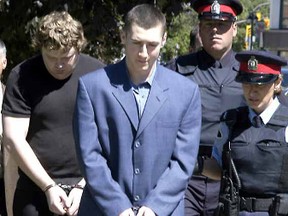 Police escort Justin Primmer (centre) and Matthew Boyes after the pair pleaded guilty to manslaughter in August 2004 in the stabbing death of Bill 'Bonesy' Welch.
Postmedia photo