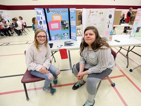 Jada Vanderveer and Macy Martin display their business plans at the Selby Public School Kidpreneur Fair on Thursday. (Meghan Balogh/The Whig-Standard/Postmedia Network)