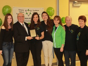 MPP Bob Bailey (second from left) and his granddaughter/translator Janessa Lavadie (far left) were at the Sarnia-Lambton French Community Centre on March 23 to present a plaque and cheque for $74,000 from the Ontario Trillium Foundation to the centre's president Tanya Tamilio (third from right). The money was given to the centre to promote health and physical fitness for Lambton County francophone youth.From left to right: Janessa Lavadie, Bob Bailey, Tiana Cooke,  Anna Luisa Cortez, Tanya Tamilio, Gus Croteau, Diane Lamarche.
CARL HNATYSHYN/SARNIA THIS WEEK