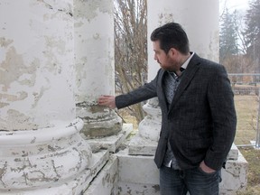 Kevin Larson, owner of the St. David Street property dubbed as the White House, shows some of the damage on the house's columns. (JONATHAN JUHA/THE BEACON HERALD)