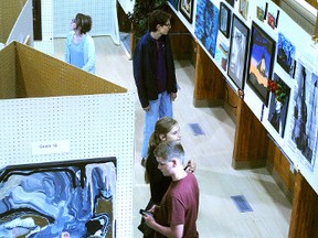 Residents view art submissions during last year's High School Art Competition — submissions for which are open until the end of April.

File Photo