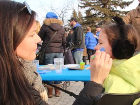 Karen Miscio paints a blue puzzle piece on the face of her daughter, Sophia, 6, Monday night at North Bay City Hall as part of Light It Up Blue. About 100 people turned out to celebrate and raise awareness of autism and to support those affected by it. 
PJ Wilson/The Nugget