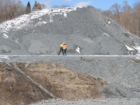 Jim Moodie/Sudbury Star
Workers walk the edge of a massive pit behind Red Oak Villa. Developer Autumnwood began excavating the land behind the retirement home this past fall, as part of a six-storey expansion that will more than double the capacity of the seniors facility.