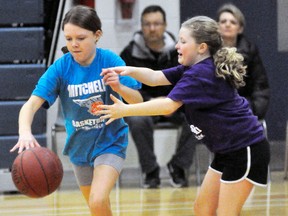 Hayden Uniac (left) is guarded by Haileigh Templeman during action from the Mitchell Minor Basketball final night, March 28. ANDY BADER/MITCHELL ADVOCATE