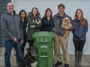 City council members Ron Chapman and his dog Scooter, Tina Petrow and her guinea pigs, and Deputy Mayor Darell Belyk and his dog Leia pose with the city's Waste and Recycling team at a compost bin now excepting pet waste on Thurs., March 29.