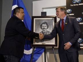 Ron Quintal, president of Fort McKay Métis, and Richard Feehan, Alberta’s Minister of Indigenous Relations, shake hands during a press conference in Edmonton on Mar. 28. The two had just announced the Métis community north of Fort McMurray bought all its land from the provincial government.