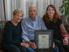 Milt Brandson poses with his wife Maureen and daughter Melanie Todd after celebrating 40 years of working as a realtor with Century 21.