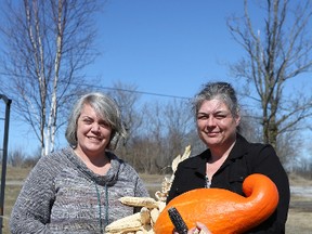 Nikki Auten and Janice Brant, both involved with Ratinenhayen:thos, hold vegetables grown from heirloom Mohawk seeds outside of Brant’s personal gardens on the Tyendinaga Mohawk Territory. (Meghan Balogh/The Whig-Standard)