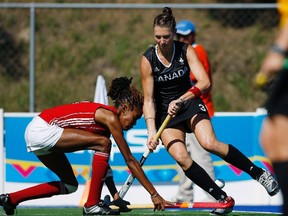Blair Wynne, left, of Trinidad and Tobado knocks the ball away from Canada’s Kate Gillis, now Kate Wright, during a Group A women’s field hockey match at the Pan American Games in Guadalajara, Mexico, in October 2011. (Alejandro Acosta/Reuters)