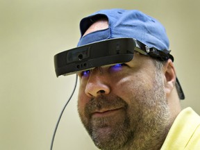 Dan Aucoin of Brantford wears electronic glasses made by Toronto-based eSight Corp that help restore sight to the legally blind. (Brian Thompson/The Expositor)