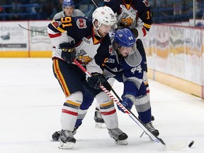 Cole Candella, right, of the Sudbury Wolves and Aaron Luchuk of the Barrie Colts, battle for the puck during OHL action at the Sudbury Community Arena in Sudbury, Ont. on Friday January 26, 2018. John Lappa/Sudbury Star/Postmedia Network  
John Lappa