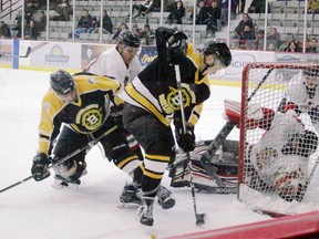 A Norway House Bruins forward attempts to hook the puck around the Sagkeeng Braves goal tender and into the net during the second period of the A-Side Men's final at the North American First Nations Tournament of Champions at Kenora Recreation Centre, Sunday, April 1. The Bruins went on to win the game 3-1 to claim the 2018 championship title.
Reg Clayton/Miner and News