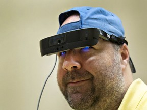 Dan Aucoin of Brantford wears electronic glasses made by Toronto-based eSight Corp that help restore sight to the legally blind. (Brian Thompson/Postmedia)