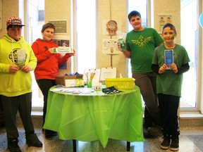 Ben Lawrence, from left, Dylan Marshall, Bladen Newman and Wyland Tone display pamphlets and information about Tourette syndrome available at a table during the Trek for Tourette event in Ayton on March 25. (Derek Lester/Postmedia Network)