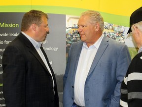 Ontario Progressive Conservative Leader Doug Ford, middle, chats with Stratford Mayor Dan Mathieson during the Canadian Dairy XPO on Wednesday, April 4, 2018 in Stratford, Ont. (Terry Bridge/Stratford Beacon Herald/Postmedia Network)