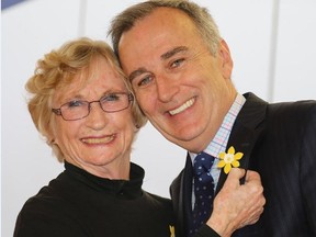 TIM MEEKS/THE INTELLIGENCER
Karen White, volunteer president at the Canadian Cancer Society's Hastings-Prince Edward and Brighton chapter, pins a daffodil to Bay of Quinte MP Neil Ellis' lapel during the official launch of Daffodil Month fundraiser Wednesday at Loyalist College.