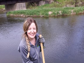 Grey Sauble Conservation Authority stewardship technician Rebecca Ferguson planting cedar seedlings along Sauble River last year. (Submitted photo).