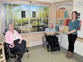 Photo by KEVIN McSHEFFREY/THE STANDARD
Patsy Bell and Romeo Francouer, two residents of the North Shore Health Network - Long Term Care, donated funds to paint the murals on the doors. They are accompanied by the artist Monique Legault.