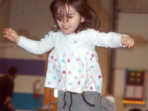 Scarlett Bembridge, 3, jumps high in the air during an Easter egg hunt for kids with special needs held on Saturday, March 31, at the Wallaceburg Flying Ws gymnastics club.