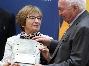 Helene Cote Sharp and Dennis Sharp receive a gift of gratitude for their $5-million donation to the future Cote Sharp Student Wellness Centre at Queen's University in Kingston, Ont. on Thursday April 5, 2018. Steph Crosier/The Whig-Standard/Postmedia Network