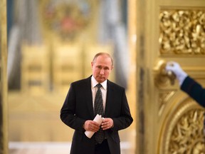 Russian President Vladimir Putin enters a hall to chair a meeting of the State Council in the Kremlin in Moscow, Russia, Thursday, April 5, 2018. (AP Photo/Alexander Zemlianichenko, Pool)