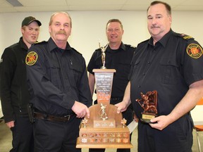 Brent Smith (right), volunteer firefighter with the South Bruce Peninsula Fire Department, Sauble Beach Station 40, was awarded the 2018 Harvey Gunnis Award at the Wiarton Arena and Community Centre, April 5. Making the presentation were Joe Martini (left), President of Bruce County Mutual Aid; Dan Robinson, manager of emergency services and Tim Wilson, deputy manager of emergency services for the Town of South Bruce Peninsula. Photo by Zoe Kessler/Wiarton Echo