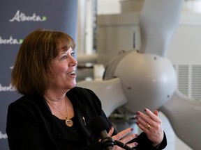 A wind turbine is visible behind Minister of Energy Margaret McCuaig-Boyd, as she announces the next stage of private-sector competitions under Alberta's Renewable Electricity Program in the Alternative Energy Technology Lab at NAIT on Wednesday, April 4.

David Bloom/Postmedia Network