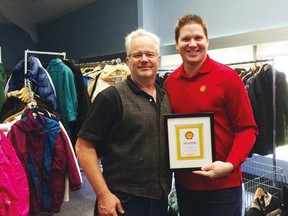 Shell Scotford external relations manager Conal MacMillan (right) presentes the Information and Volunteer Centre of Strathcona County with a grant in a previous round of Shell Community Grants — applications for which are now open for the fifth year.

File Photo