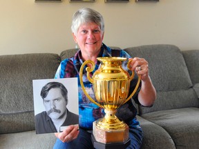 The late Rick Wood, a marathon swimming icon within Ontario, is part of the Norfolk County Sports Hall of Recognition Class of 2017. Pictured, Wood's sister Debbie Gibbons holds a picture of him along with a trophy he won after successfully crossing Lake Ontario in 1989.
JACOB ROBINSON/Simcoe Reformer