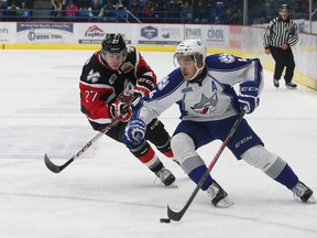 Nick Baptiste, right, of the Sudbury Wolves, attempts to get by Cody Caron, of the Niagara IceDogs, during OHL action at the Sudbury Community Arena in Sudbury, ON. on Friday, November 29, 2013. JOHN LAPPA/THE SUDBURY STAR/QMI AGENCY