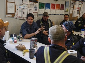 Prime Minister Justin Trudeau meets with workers at Suncor's Fort Hills facility north of Fort McMurray, Alta., on Friday, April 6, 2018. THE CANADIAN PRESS/Jason Franson