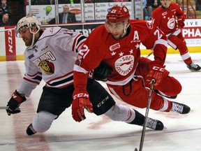 Sault Ste. Marie Greyhounds defenceman Conor Timmins (right) and Owen Sound Attack centre Brett McKenzie mix it up during first-period OHL playoff action Thursday evening at Essar Centre. JEFFREY OUGLER/SAULT STAR/POSTMEDIA NETWORK