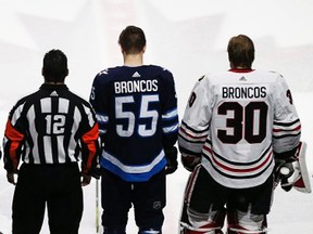 The Chicago Blackhawks and Winnipeg Jets wore jerseys with BRONCOS on the back for their NHL game Saturday in Winnipeg to honour the memory of the 15 members of the Jr. A hockey club who died in a horrific bus crash Friday in Saskatchewan. (John Woods/Canadian Press)