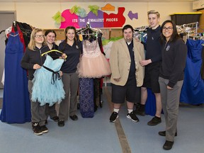 Special needs student Stacie Ritchie (left) looks over some dresses last week at Assumption College with leadership students Jenna Gleason and Charish Halliday, while Caleb Kendrik tries on a suit jacket with leadership students Andrew Faller-Saunders and Ireland Connell. Leadership program students have gathered over 100 prom dresses, suits, shoes and pieces of jewelry to help special needs students participate in a no barriers prom. 
Brian Thompson/The Expositor