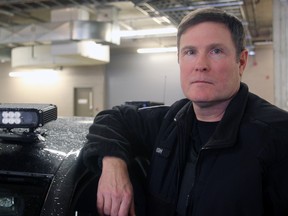 Const. Richard Hough, of the Kingston Police Traffic Unit, with a cruiser equipped with an Automatic Licence Plate Reader at Kingston Police Headquarters in Kingston, Ont. on Wednesday, March 14, 2018.