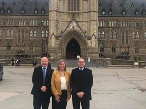 Whitecourt Mayor Maryann Chichak (middle) and Whitecourt Town councillor Ray Hilts (right) stand on Parliament Hill during a trip regarding the Caribou Range Plan on March 29 (Supplied | Facebook).