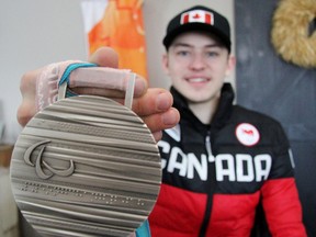 Monkton’s Corbyn Smith holds his silver medal he won as a member of Canada’s Paralympic sledge hockey team. CORY SMITH/POSTMEDIA NETWORK