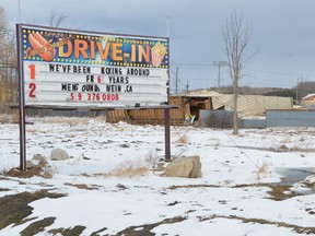 An excavator sits next to the toppled screen at the site of the former Owen Sound Twin Drive-In Theatre at Springmount on Monday afternoon. The owner has confirmed the drive-in has closed for good. (Rob Gowan The Sun Times)
