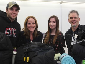 From left, Child and Youth Worker student Kristian van der Horden, teacher Rachel Dutcher, fellow student Kayla Verot, and Doug van der Horden with backpacks packed by students for victims of human trafficking at St. Lawrence College in Kingston, Ont. on Friday April 6, 2018. Steph Crosier/The Whig-Standard/Postmedia Network