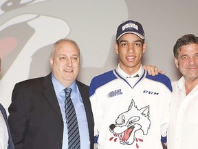 Quinton Byfield, Sudbury Wolves' first overall pick at the 2018 Ontario Hockey League draft, poses for a picture with (left to right), Cory Stillman head coach, Rob Papineau, general manager, and Dario Zulich, owner.