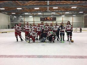 The North East Warriors recreational hockey team poses with their crests honouring the Humboldt Broncos following the Banff Cup last weekend.