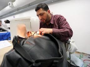 Fadi Hossain fixes a backpack at the grand opening event for the Kingston Repair Cafe on Sunday, April 8, 2018. Meghan Balogh/The Whig-Standard/Postmedia Network