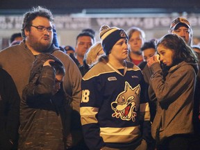A group of Sudburians, including Greater Sudbury Fire Services, EMS and police, gathered in front of the Sudbury Community Arena to show support for the community of Humboldt Saskatchewan in Sudbury, Ont. on Sunday April 8, 2018. The vigil was held to honor the victims of the truck-bus crash that killed 15 team member and staff of the Humboldt Broncos. Gino Donato/Sudbury Star/Postmedia Network