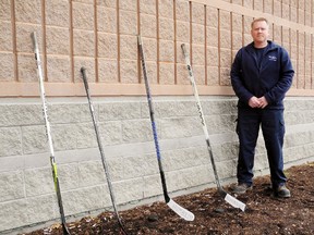 Hockey sticks have been posted outside homes, businesses and institutions across Canada in solidarity with the small town of Humboldt, Saskatchewan. The town of 5,800 was devastated Friday when 15 people aboard the Humboldt Broncos’ Jr. A hockey team bus were killed in a collision with a transport truck. Keeping an eye on the makeshift shrine outside the Port Dover & Area Arena Tuesday was arena lead hand Rob Vandendriessche. MONTE SONNENBERG / SIMCOE REFORMER